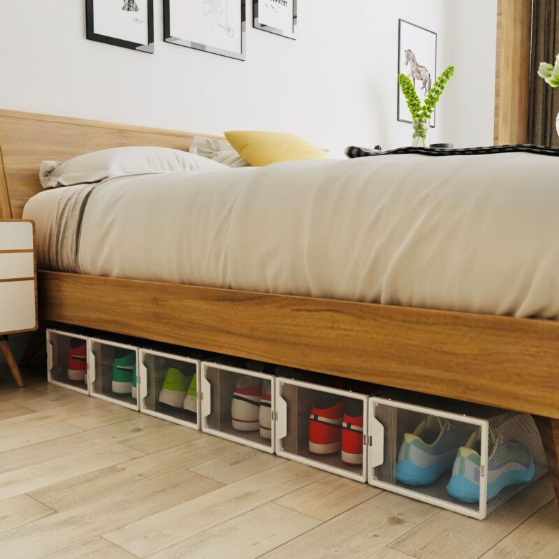 Transparent shoe storage boxes neatly arranged under a bed.